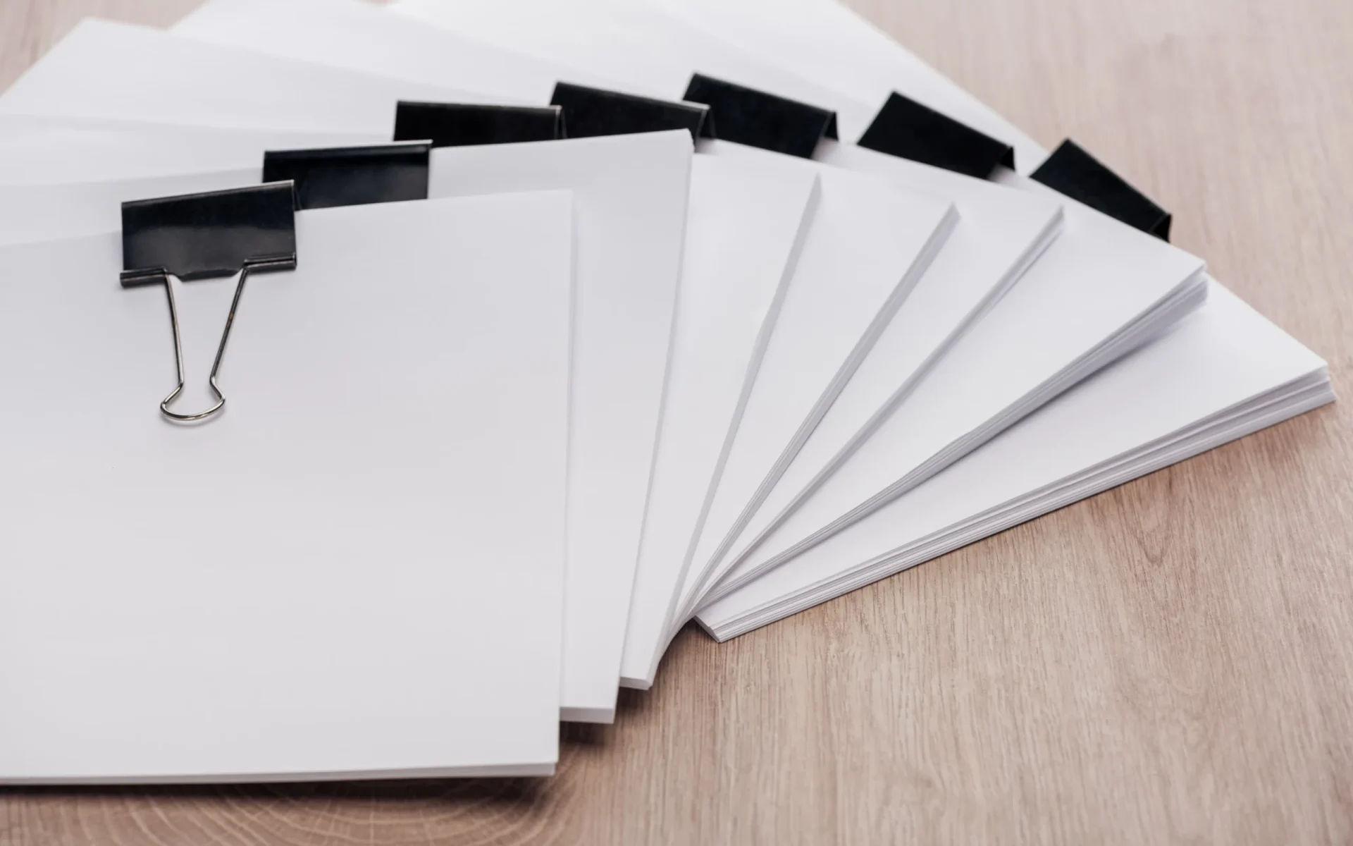 stacks-of-blank-paper-with-metal-binder-clips-and-2024-11-19-18-17-38-utc